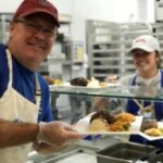 The kitchen crew plates a meal